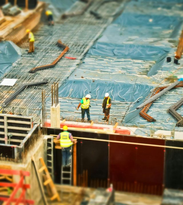 High-angle view of construction workers on a building site, engaging in construction work.
